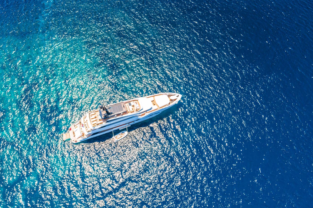 An image of a yacht sailing in sea.