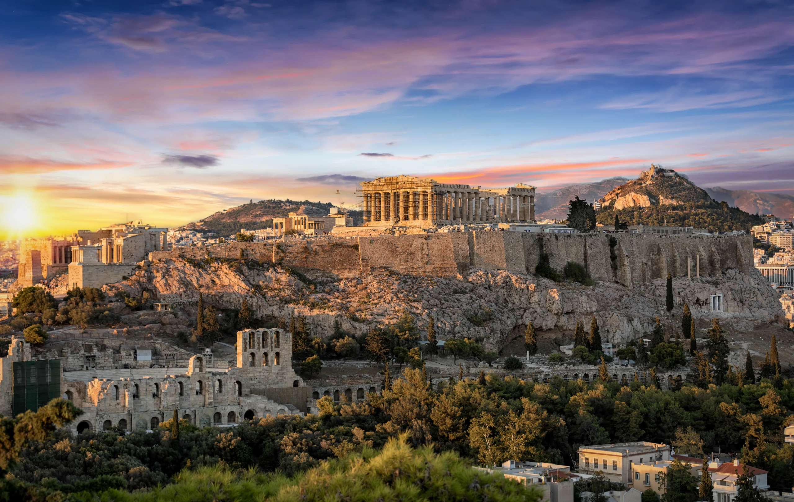 The Parthenon Temple at the Acropolis of Athens, Greece, during colorful sunset.