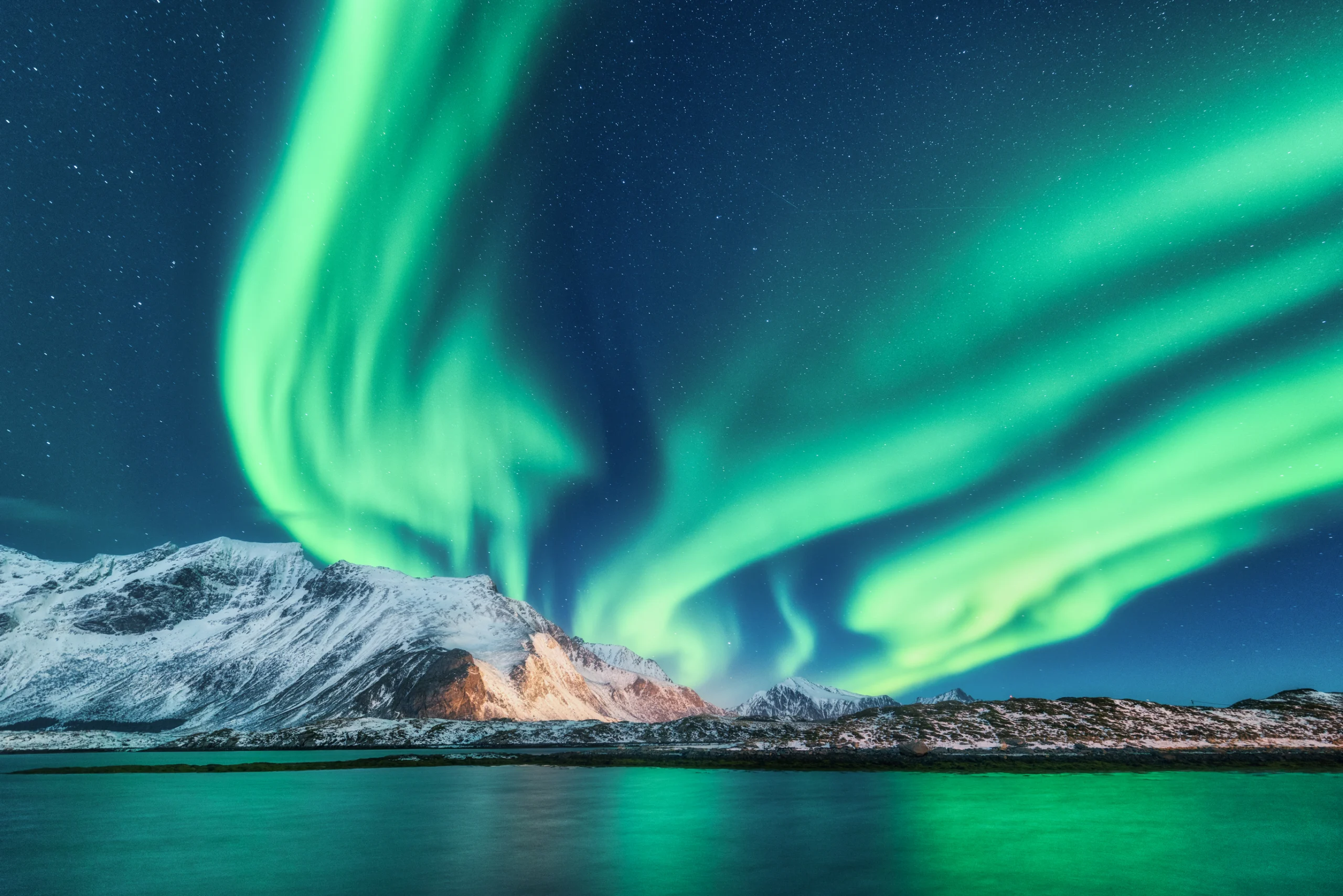 Green northern lights in Lofoten islands, Norway, Aurora borealis.