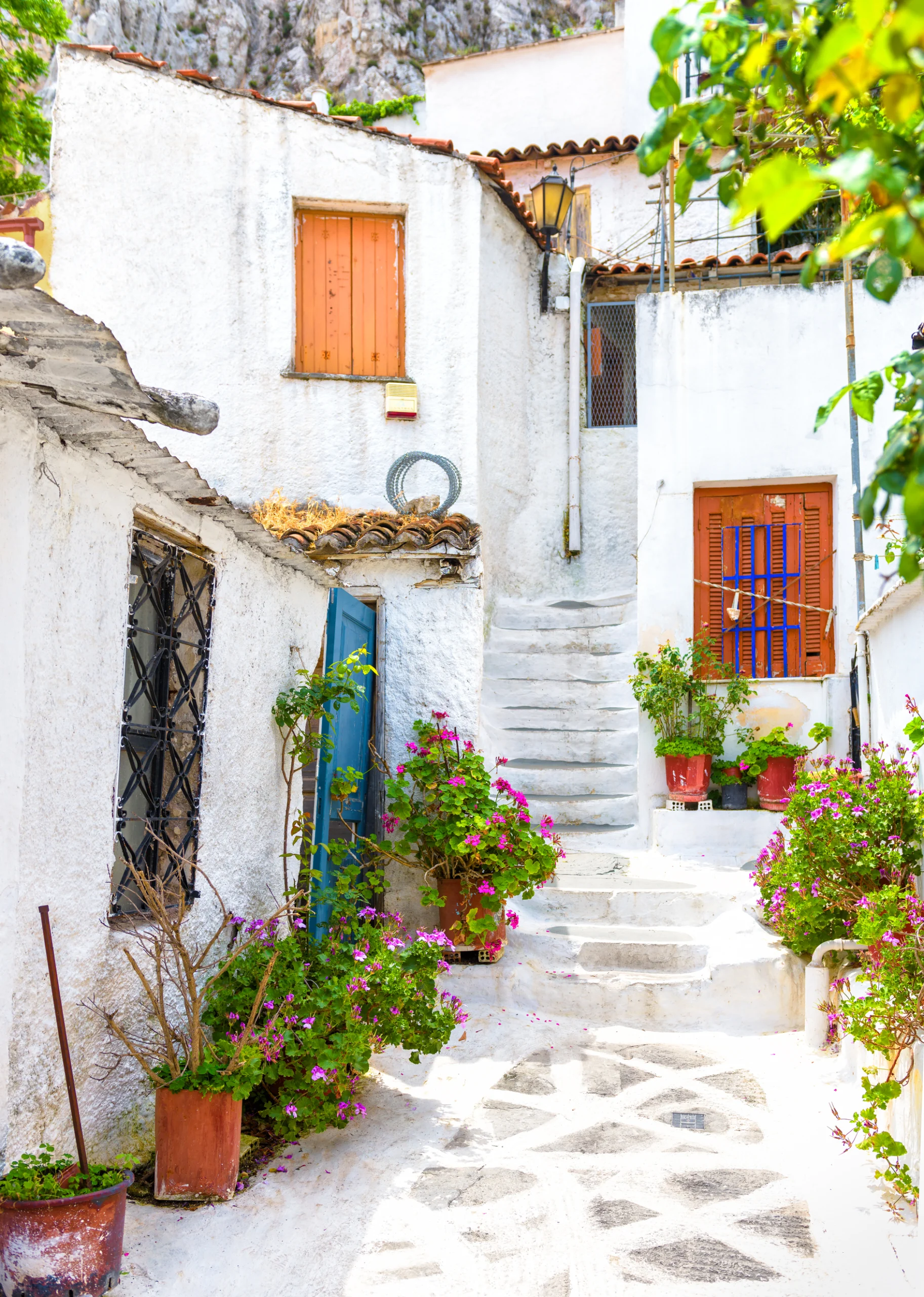 Old narrow street with flowers in Anafiotika, Plaka district, Athens, Greece.
