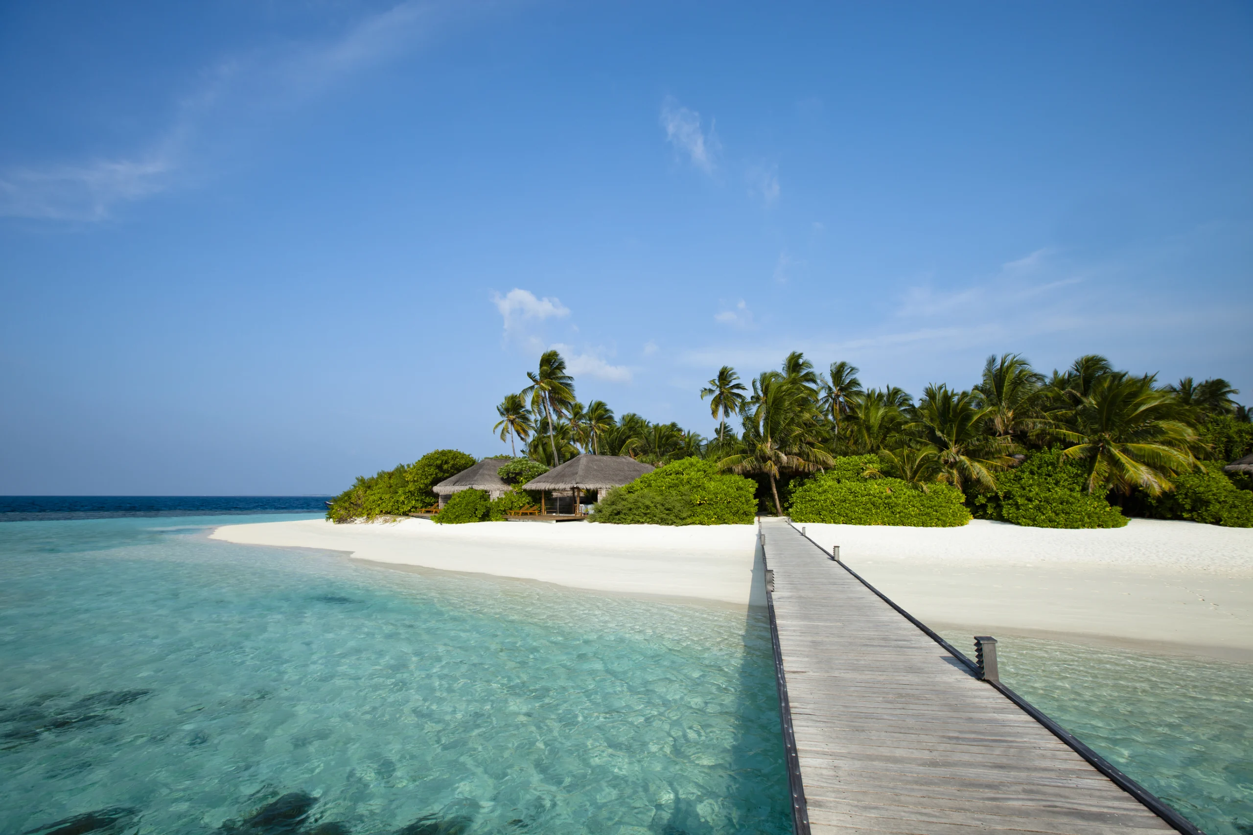 A wood pontoon access to paradise beach of a tropical island.