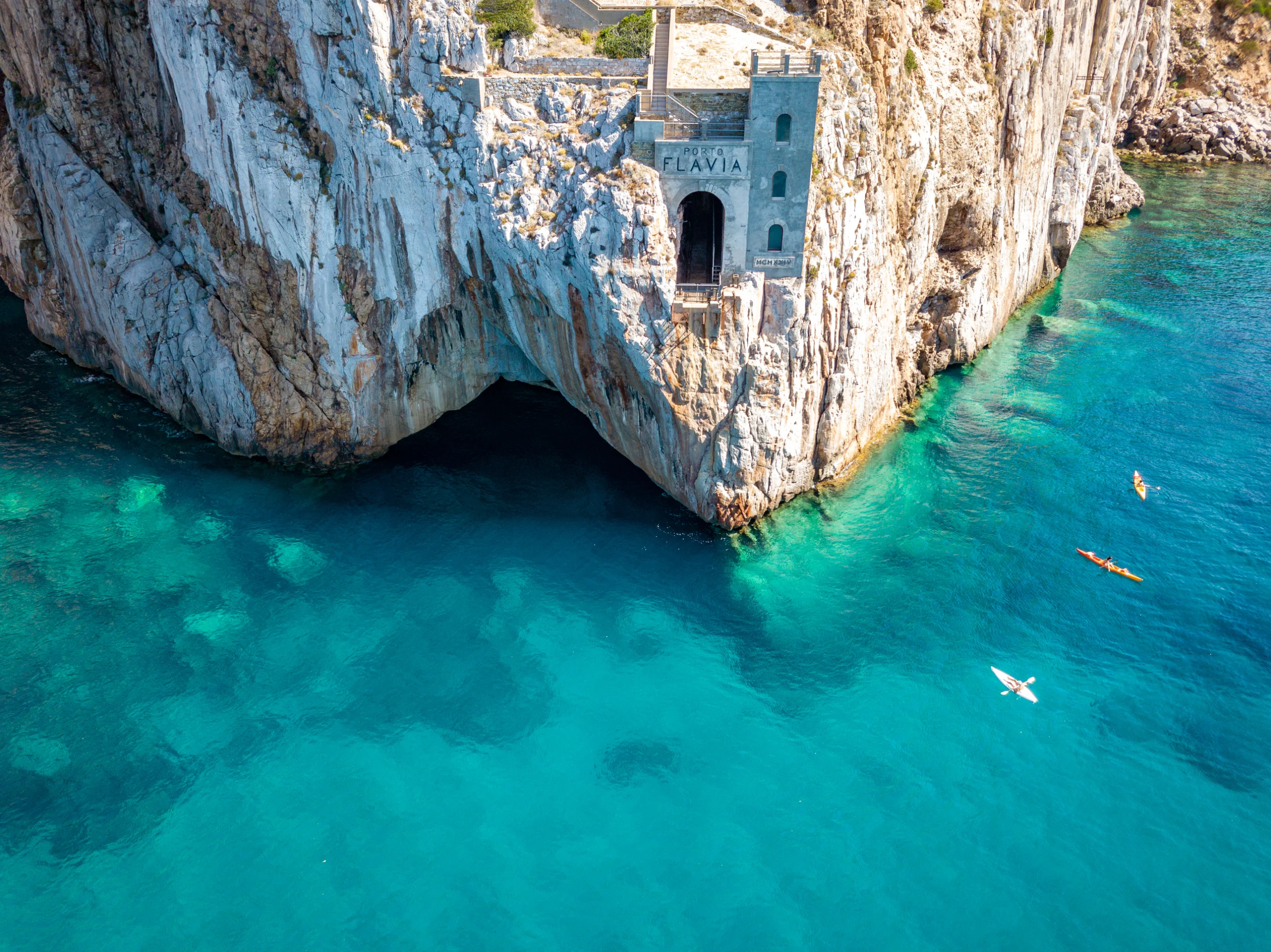 Aerial view of sea and coastline, Sardinia, Italy. Porto Flavia, kayaks.