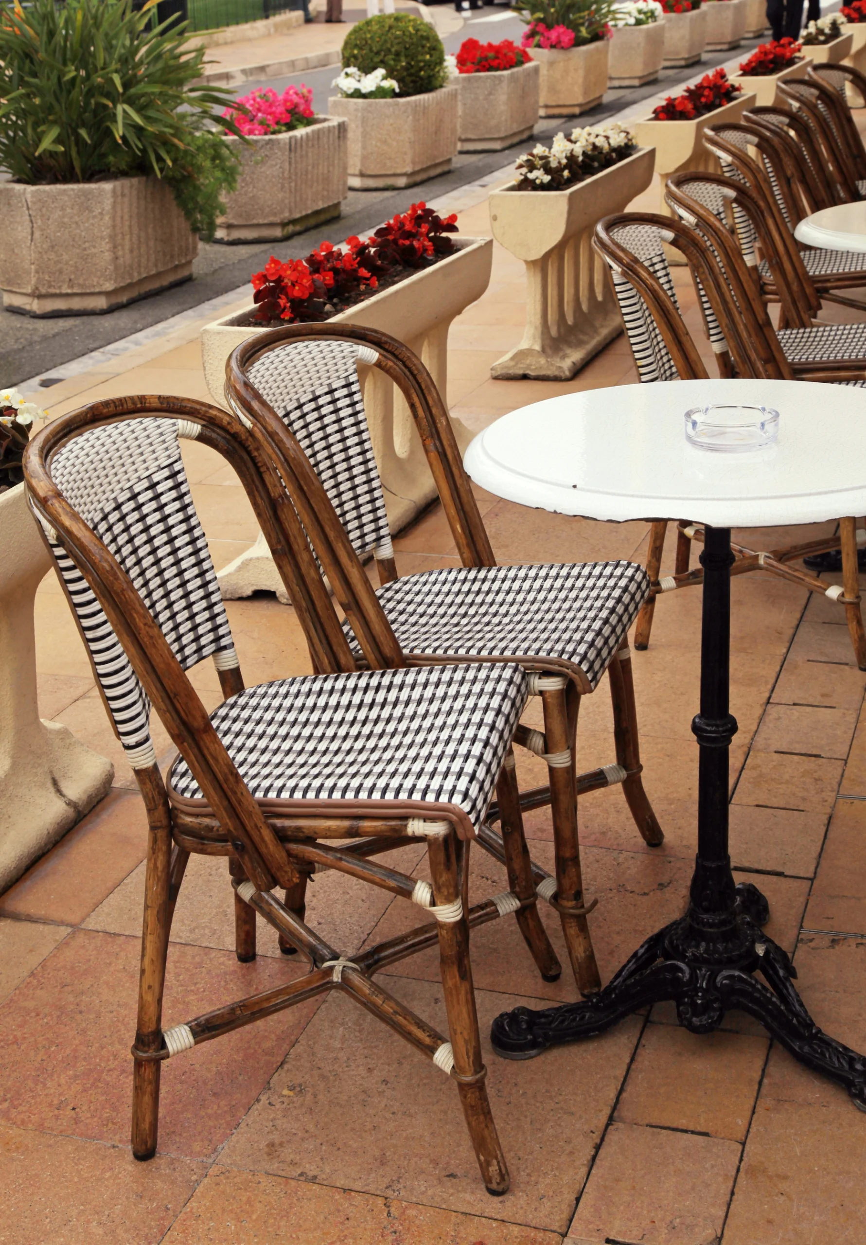 Beautiful french sidewalk cafe with small round tables and wicker chairs, Monaco.