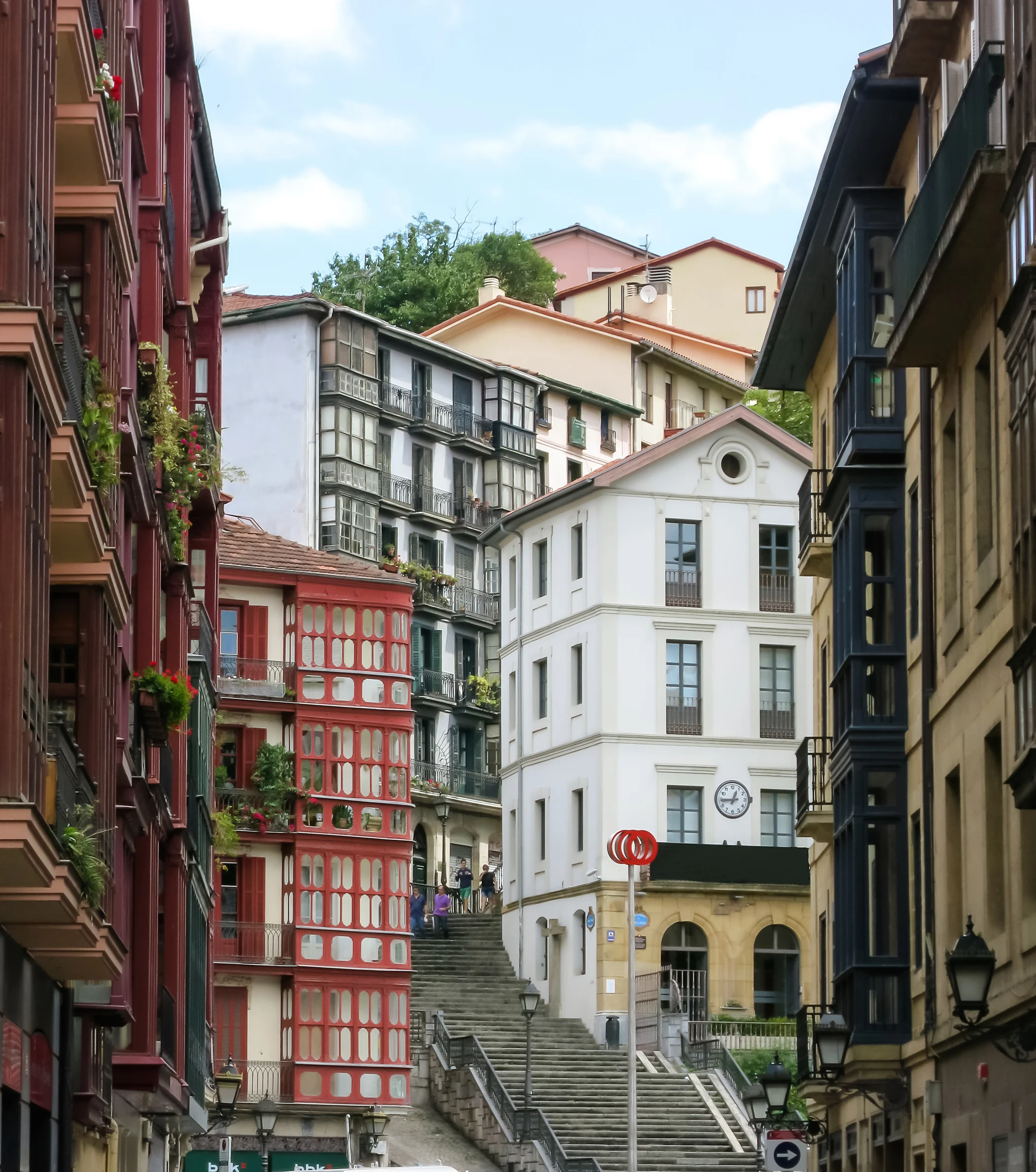 City landscape of a small, cozy street with cascaded houses in Bilbao, Spain.