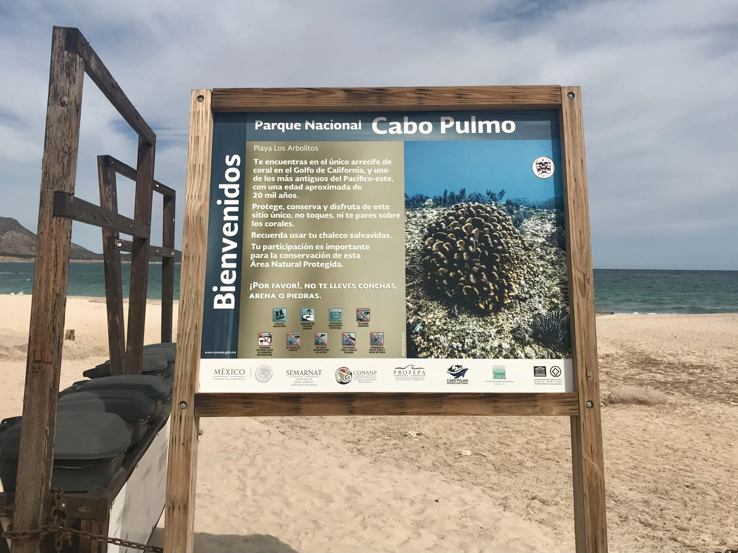 Cabo Pulmo National Park sign on beach.