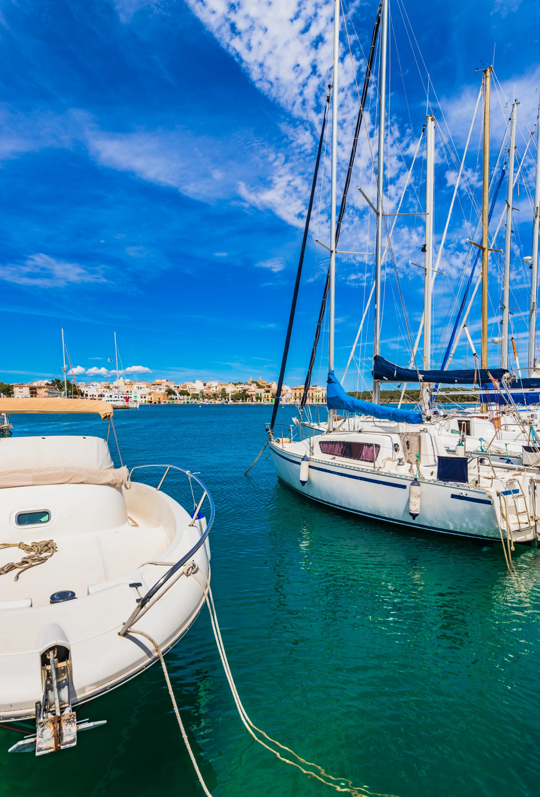 Majorca, sailboats moored at coast of Porto Colom.