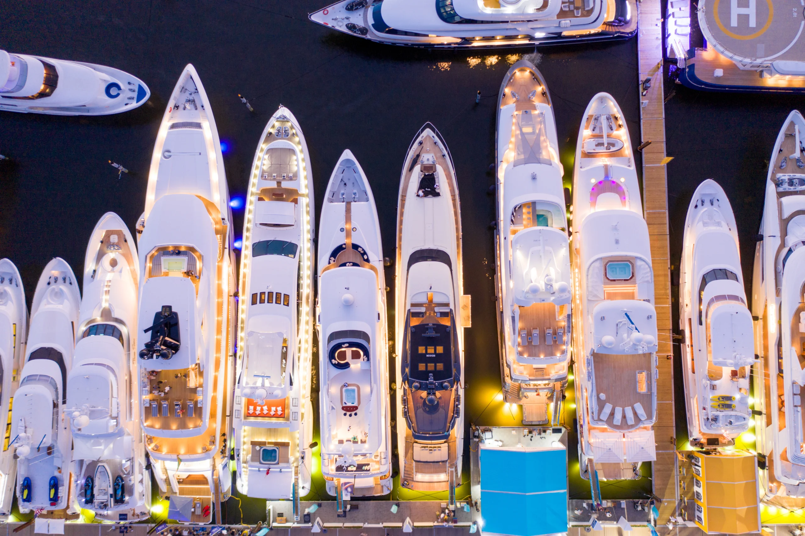 Ariel direct overhead shot of luxury Super yachts lit at night Fort Lauderdale international boat show USA