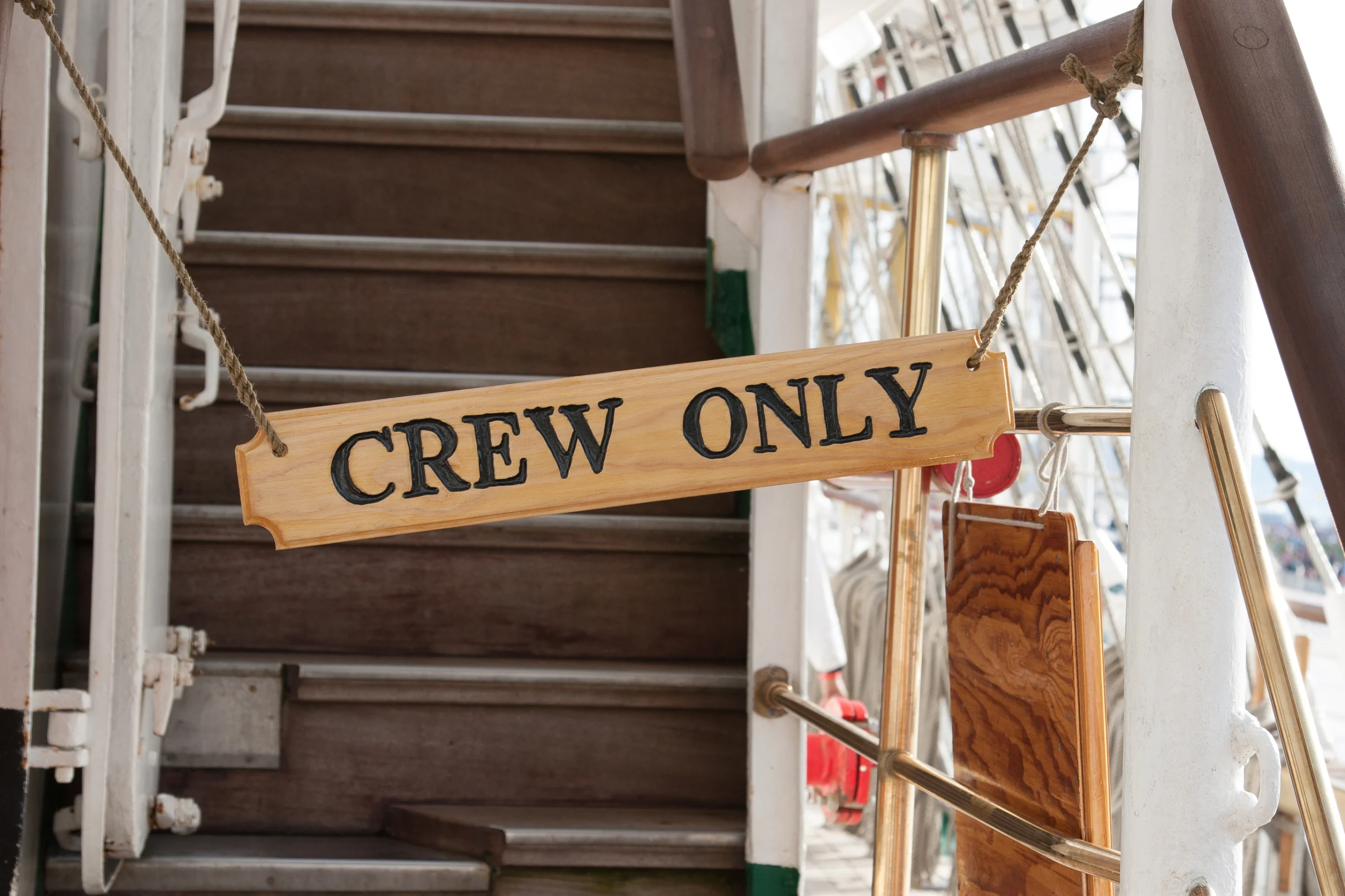 Wooden sign of crew only.