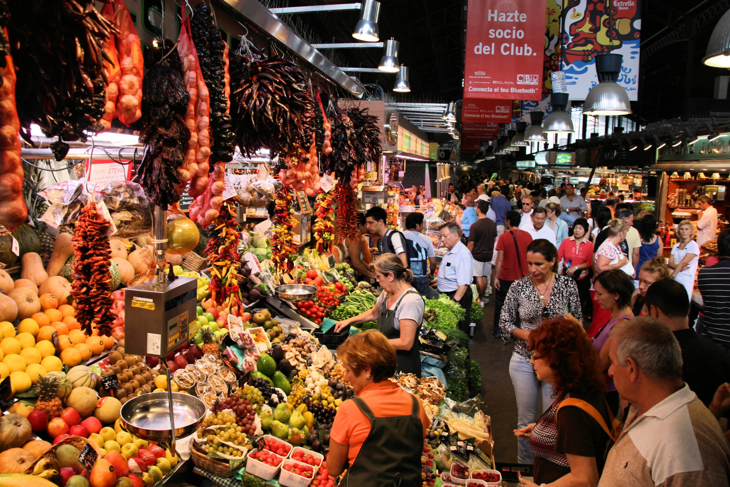 Tourists in famous La Boqueria market, Barcelona.