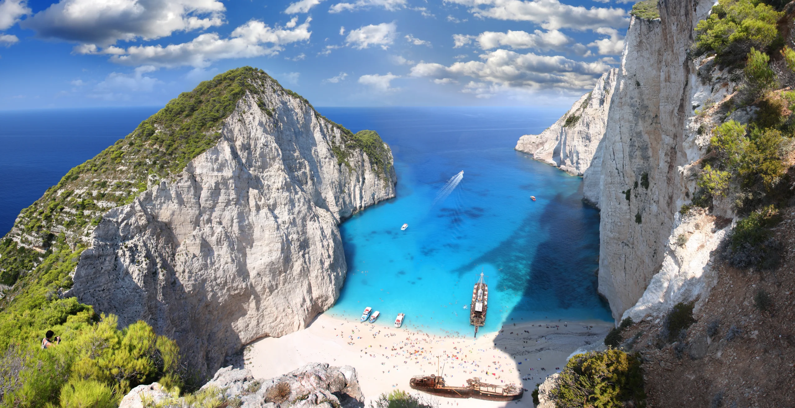 Famous Navagio Beach, Zakynthos, Greece. Navagio beach with sailboats in Zakynthos Island, Greece, part of Ionian Islands