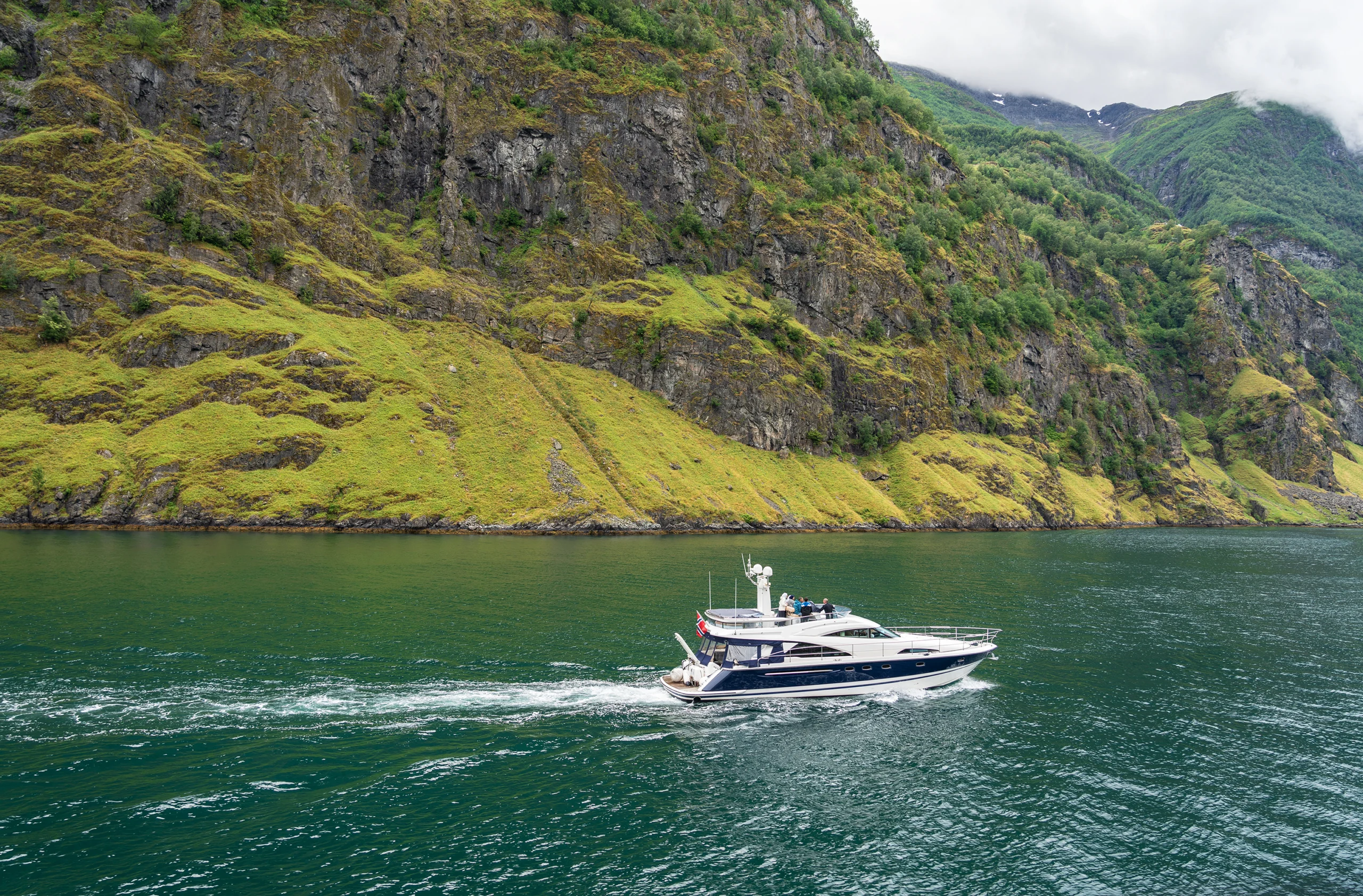 Yacht sailing in Sognefjord mountains, Norway.