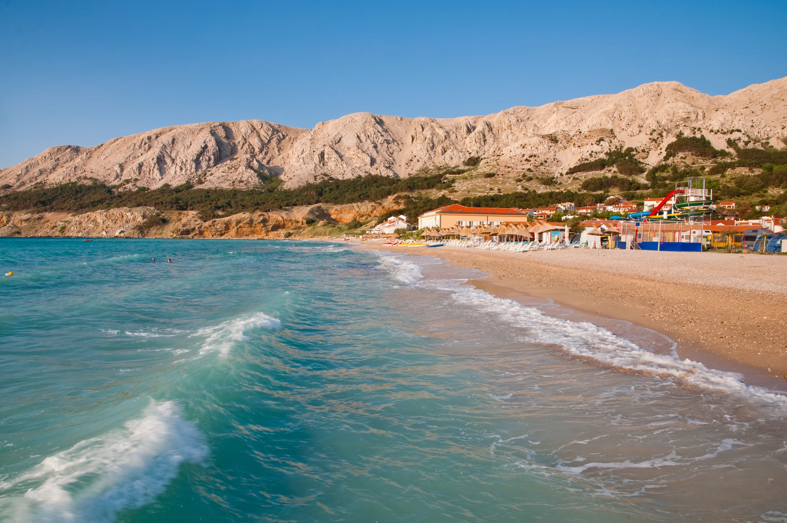 Waves on sea and touristic beach at Baska - Krk - Croatia