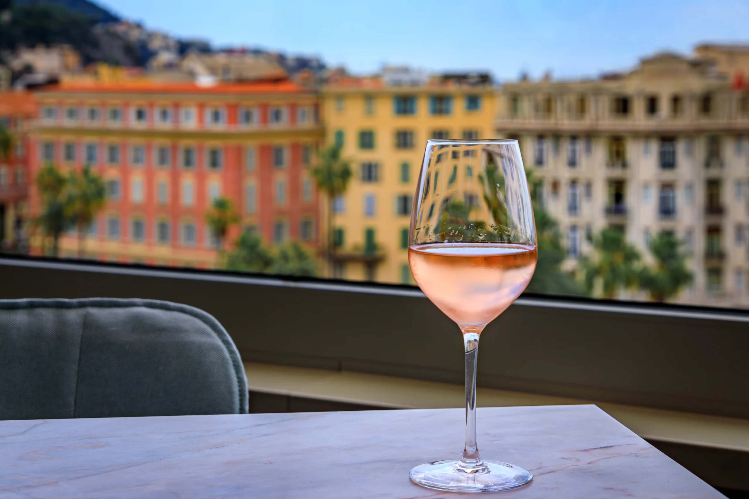 Glass of rose wine at an outdoor restaurant in Old Town of Nice, South of France.