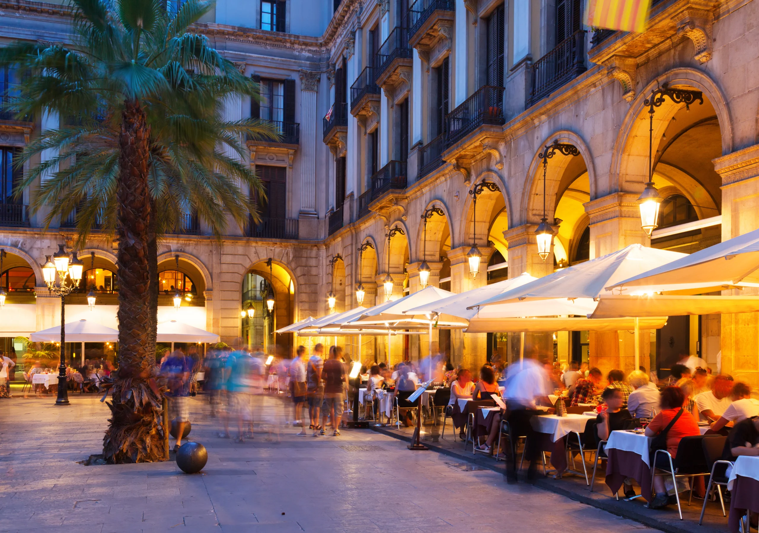 Night view of Placa Reial with restaurants in summer, Barcelona.