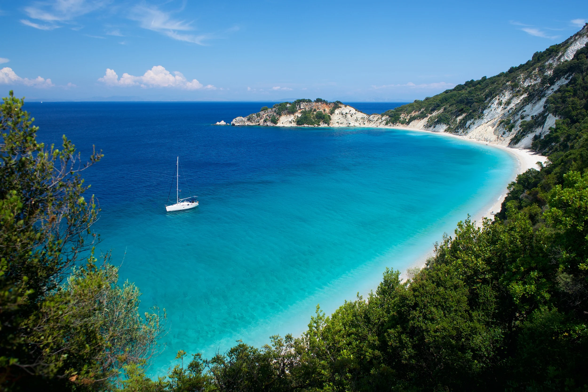 Light blue water on beach with sail on Gidaki on the Ithaca Ithaki or Ithaka island like paradise with blue sky in Greece Europe
