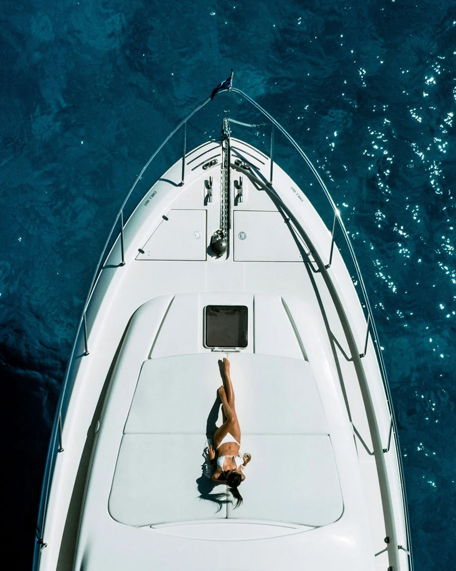 An image of a woman lying on a yacht deck