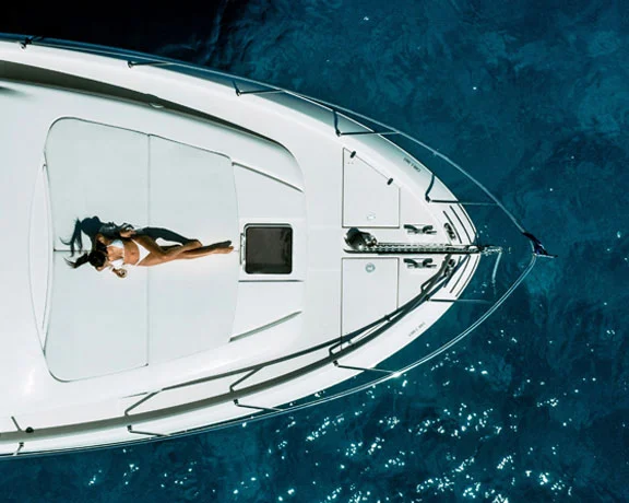 An image of a woman lying on a yacht deck
