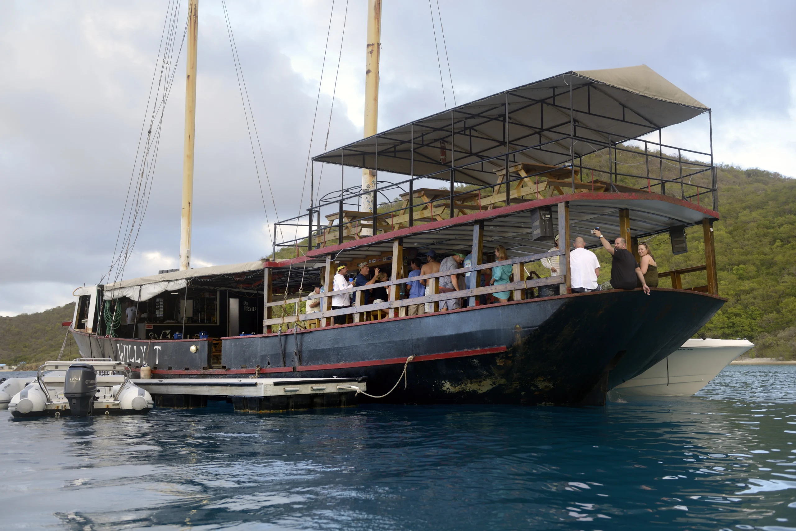The William Thornton Floating Bar & Restaurant schooner, an old steel ship about 100 feet long, The Bight, Norman Island, British Virgin Islands