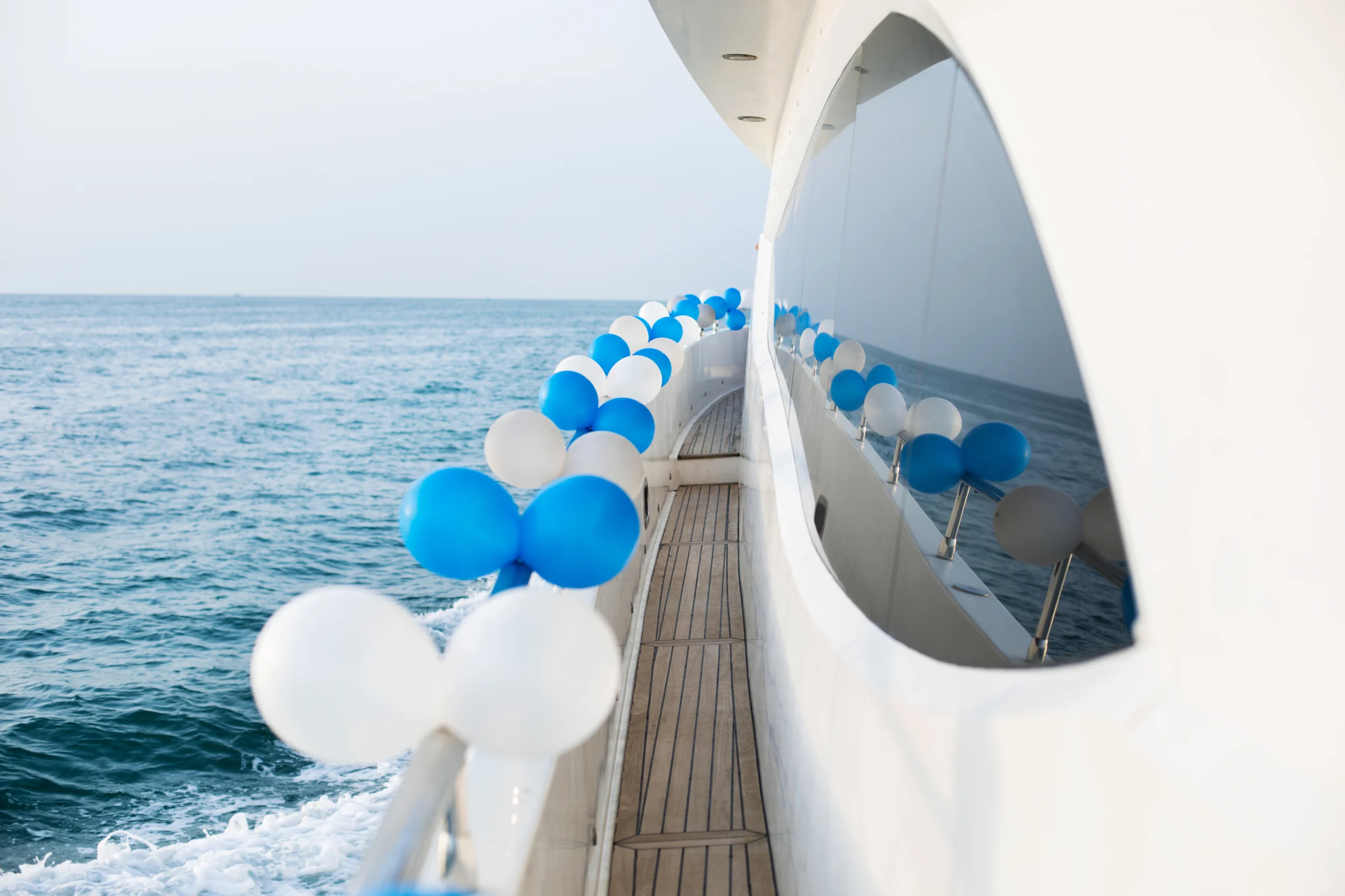 The exterior of a luxury yacht decorated with balloons
