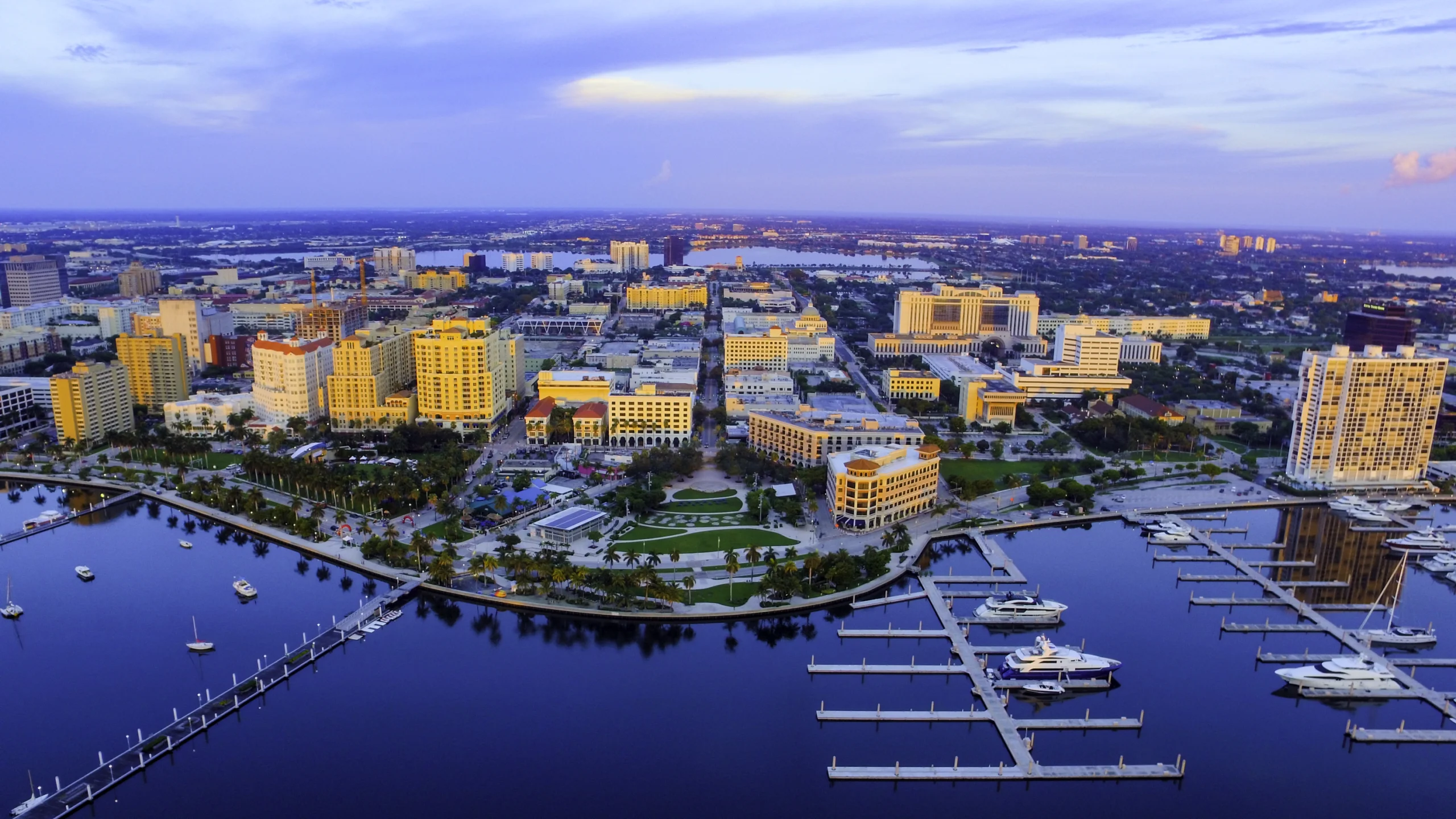 Aerial shot of downtown west palm beach, florida looking west down clematis street catching a glance of the yacht docks and marina