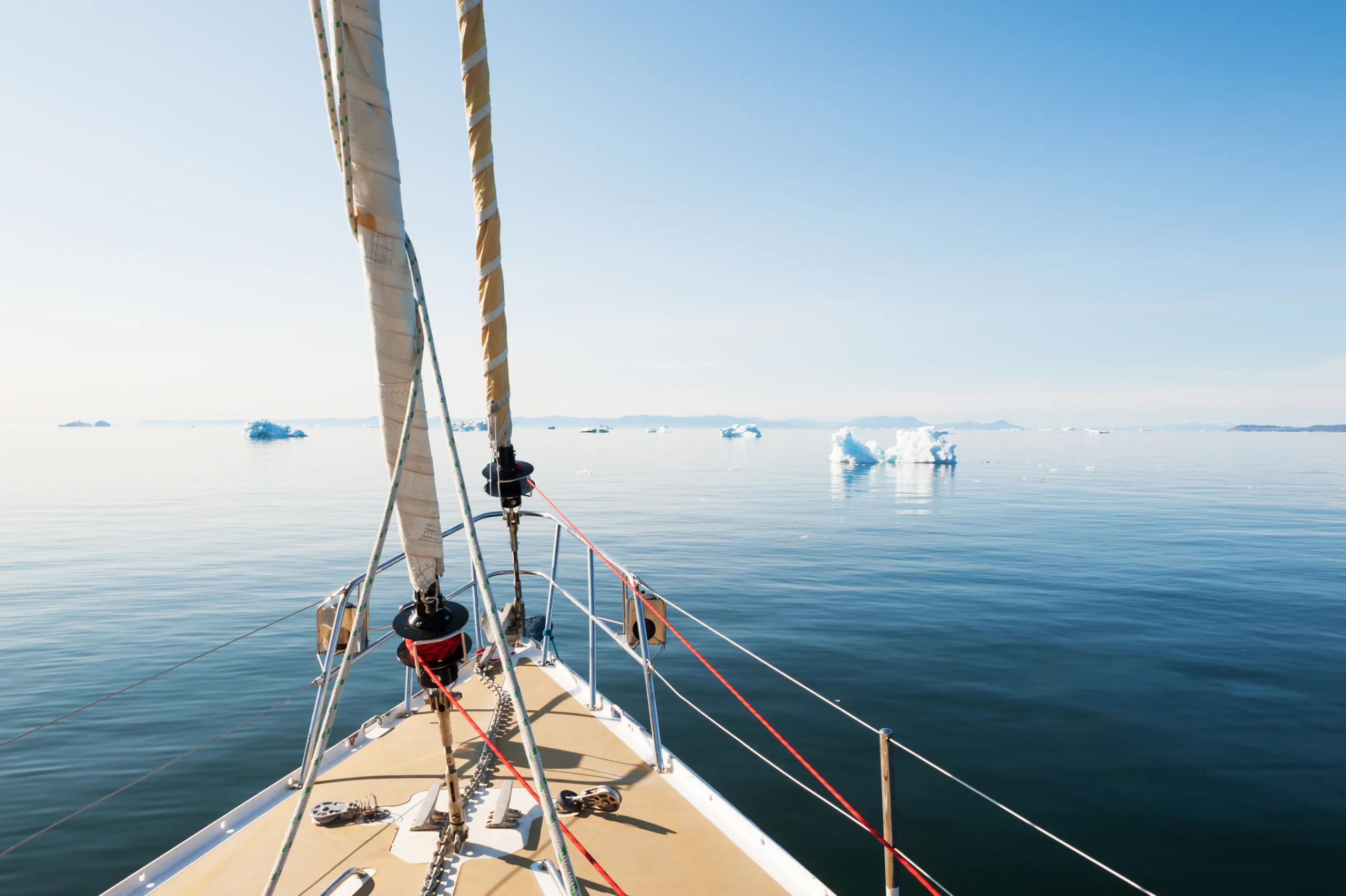 Travel by yacht among icebergs in Greenland.
