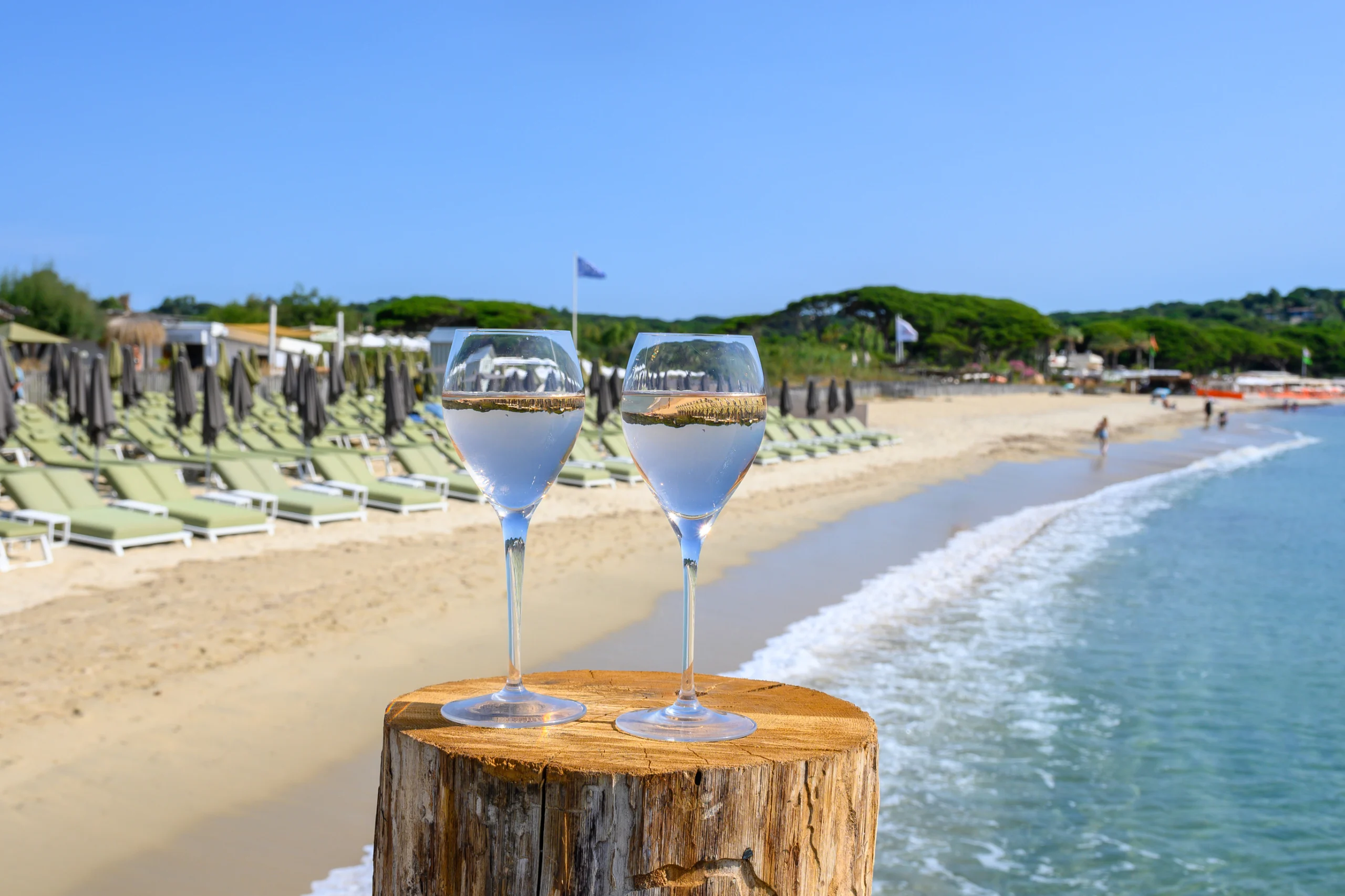 Summer time in Provence, two glasses of cold rose wine on Pampelonne sandy beach near Saint-Tropez in sunny day, Var department, France