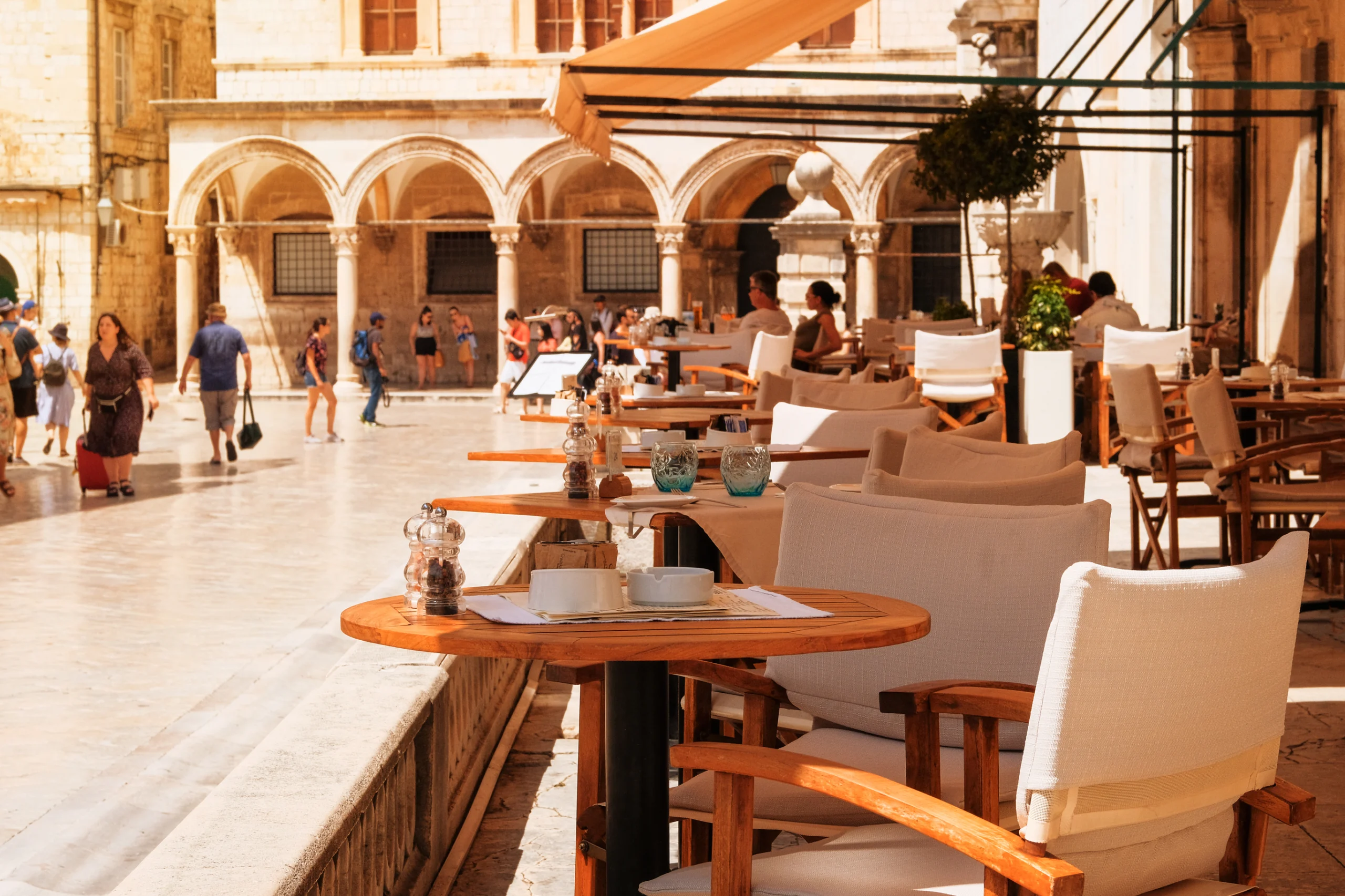 Summer in Croatia, Dubrovnik. Table setting on summer terrace of cozy restaurant