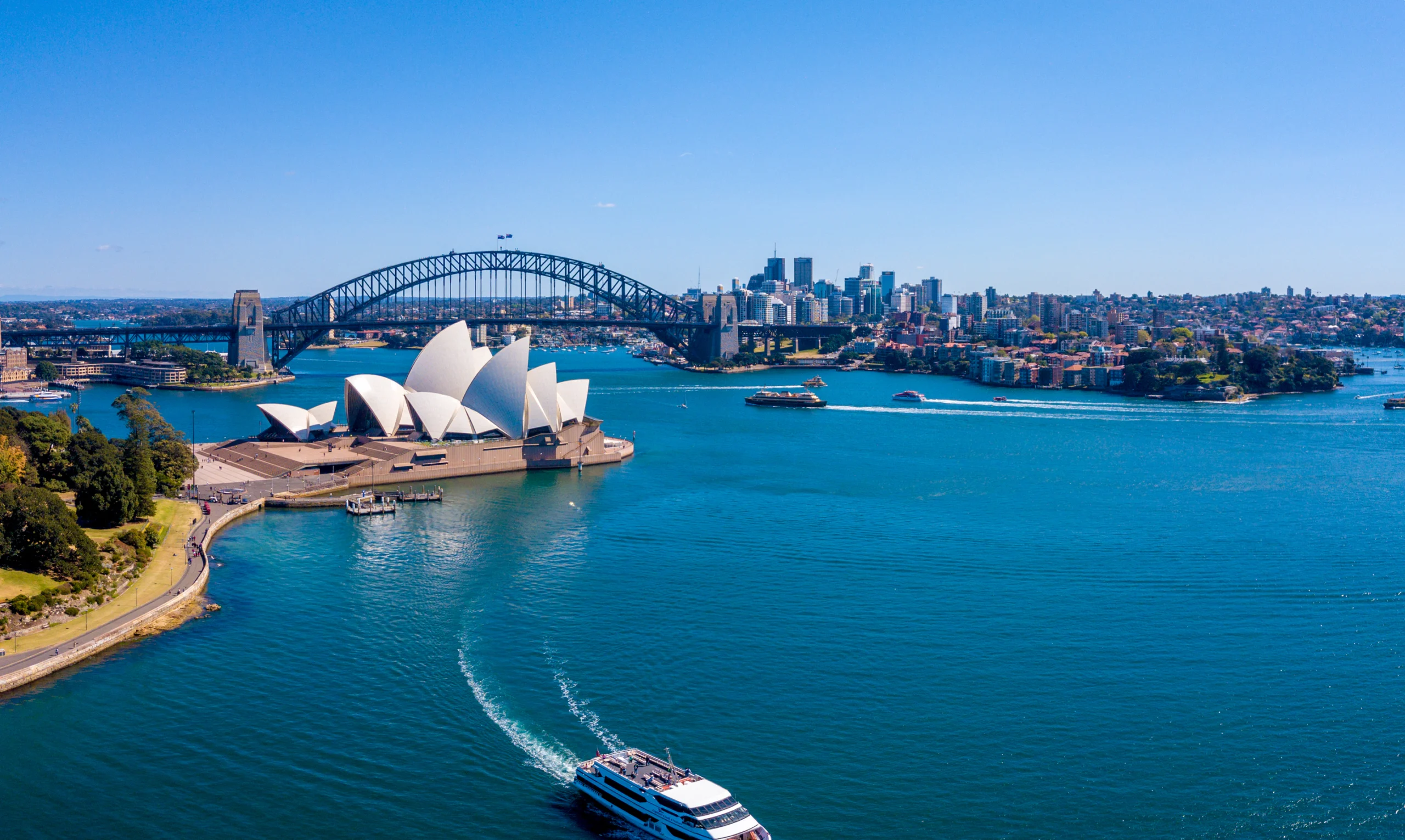 Aerial View of the Sydney Harbour Bridge and Opera House. Aerial view on the Sydney harbour from above with city skyline, botanic garden, park and of course the Harbour bridge.