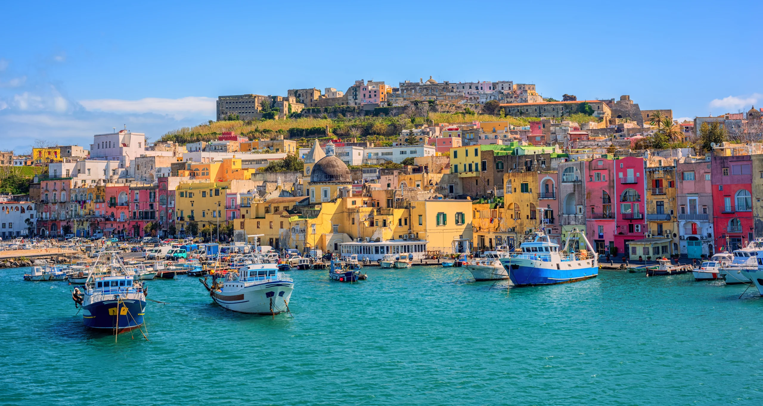 Port of Procida island in Gulf of Naples, Italy. Colorful houses and boats in the port of Procida town, island of Procida, Gulf of Naples, Italy