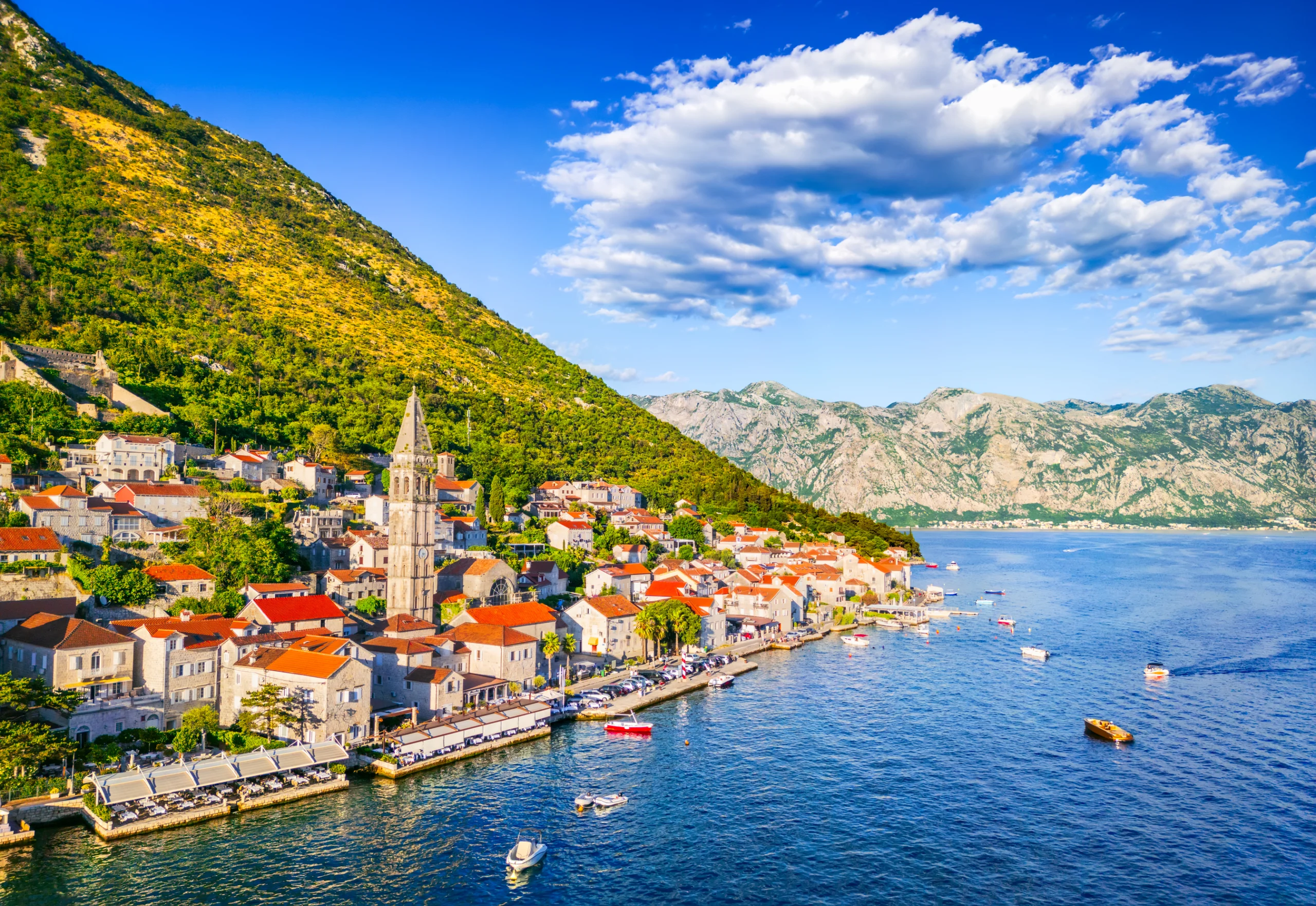 Perast, Montenegro. Aerial drone view Bay of Kotor. Aerial drone view of the hillside town highlighting the tall church tower along the Bay of Kotor.