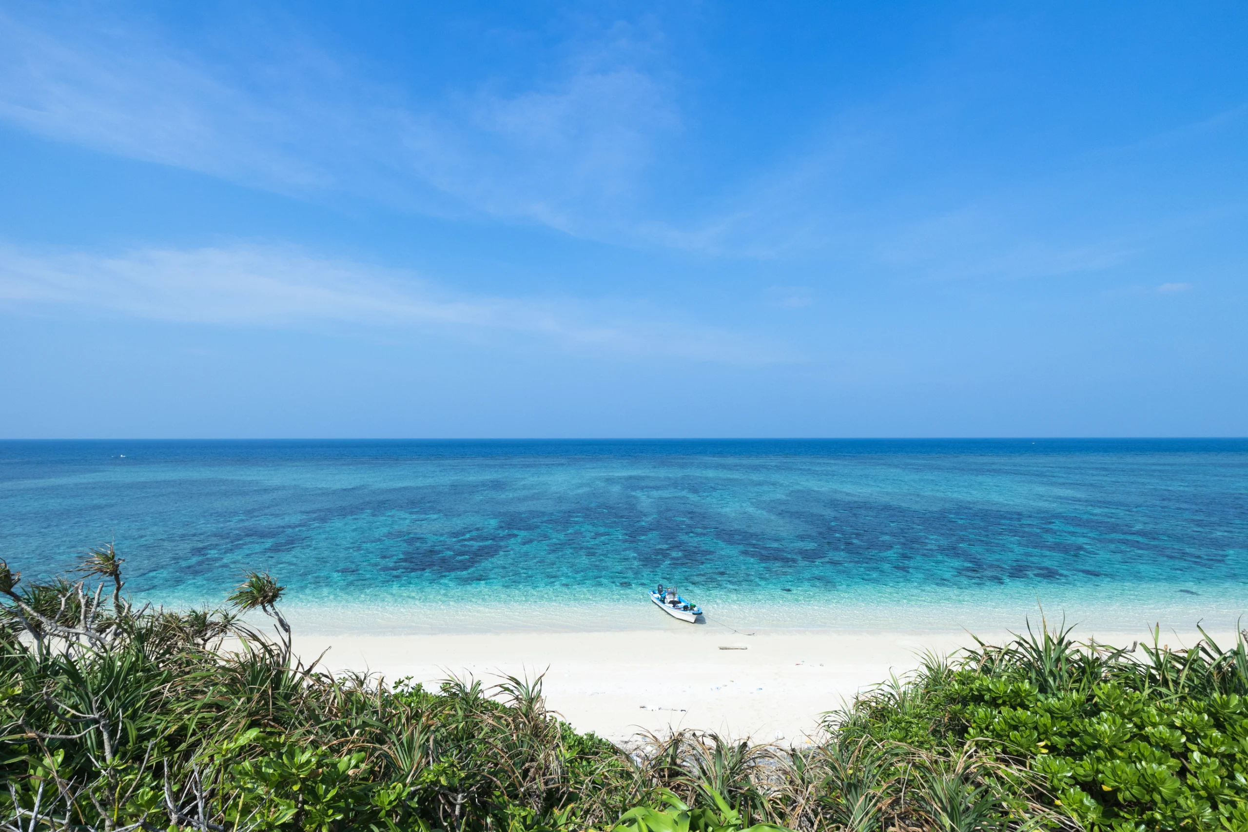 Deserted tropical island beach and clear blue water, Okinawa, Japan. Crystal clear blue water and white sand tropical beach from above, Yaeyama Islands of Okinawa, Japan