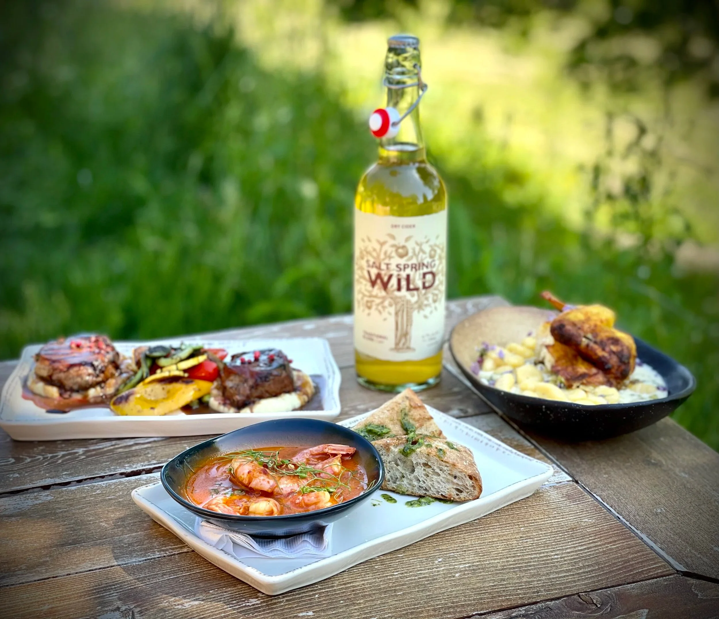 drinks and food on a platter at Salt Spring Wild Cider