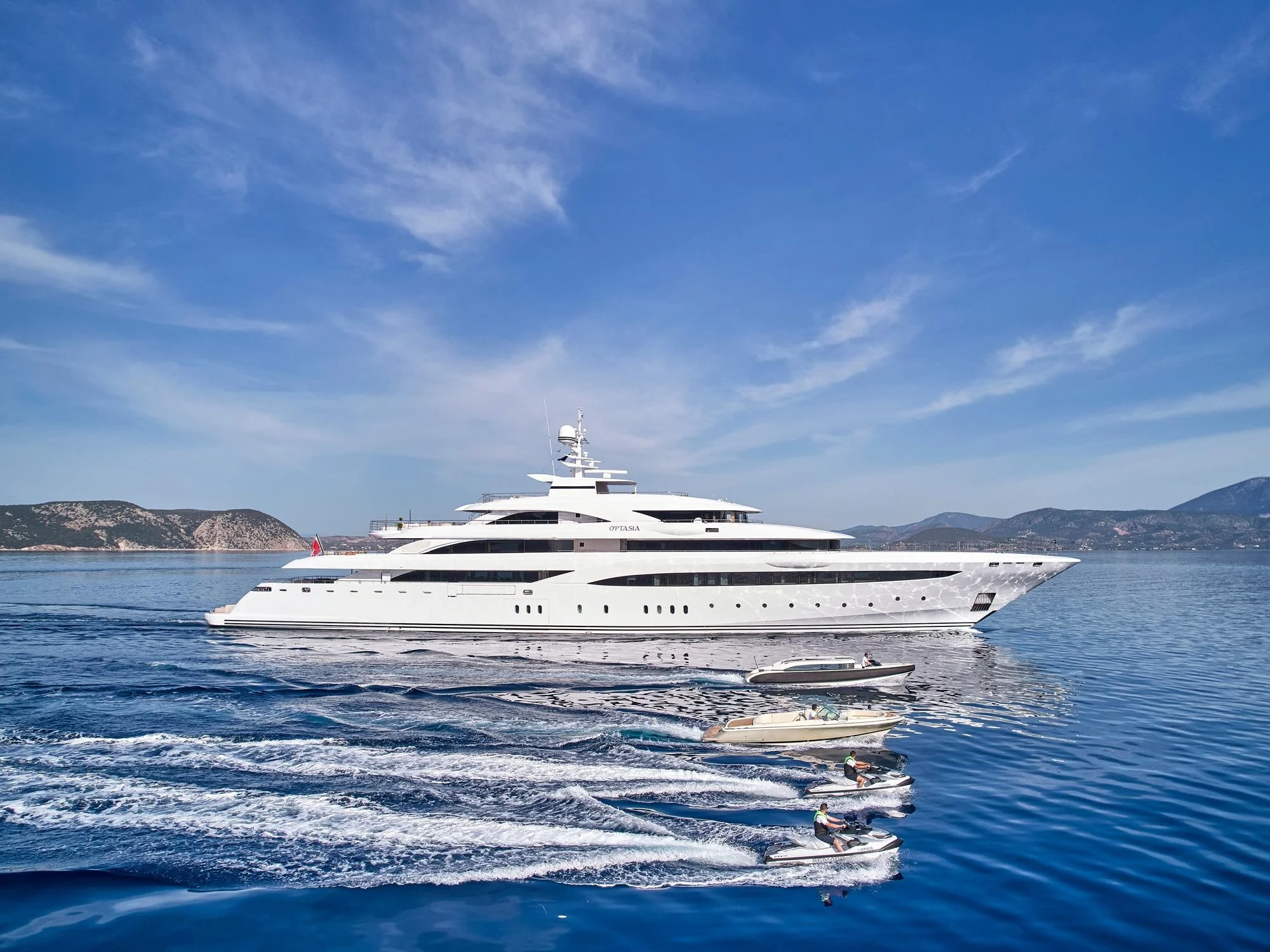 yacht in water with smaller boats on its side